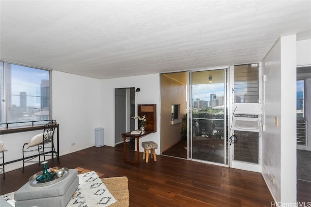 living room with dark hardwood / wood-style flooring and floor to ceiling windows