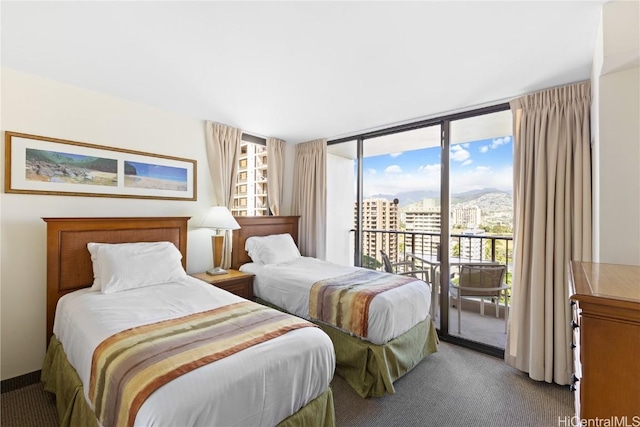 carpeted bedroom featuring expansive windows and access to outside