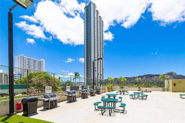 view of community with a patio and a mountain view