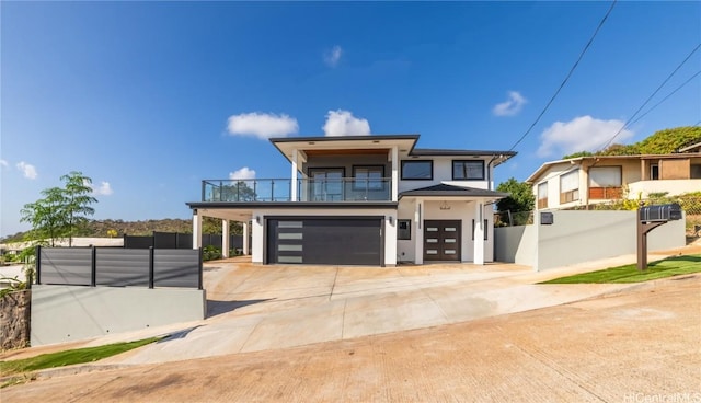 view of front of home featuring a balcony and a garage