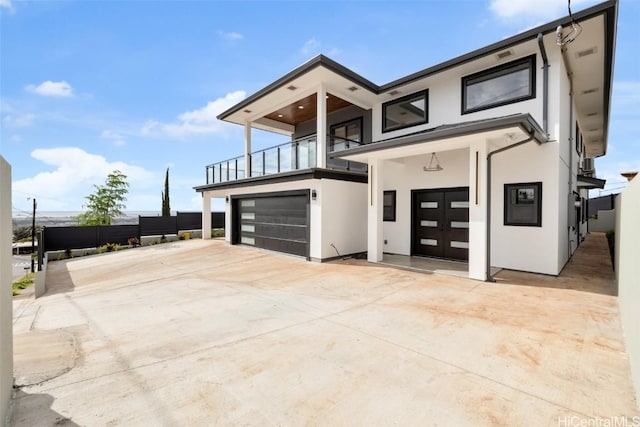 contemporary house with a garage and a balcony