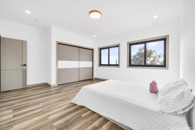 bedroom featuring light hardwood / wood-style floors and a closet