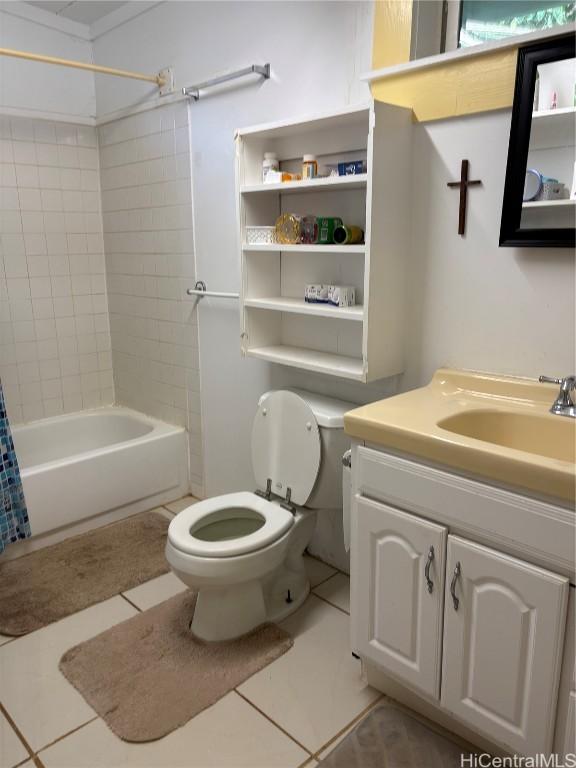 bathroom featuring shower / bathtub combination with curtain, vanity, toilet, and tile patterned floors