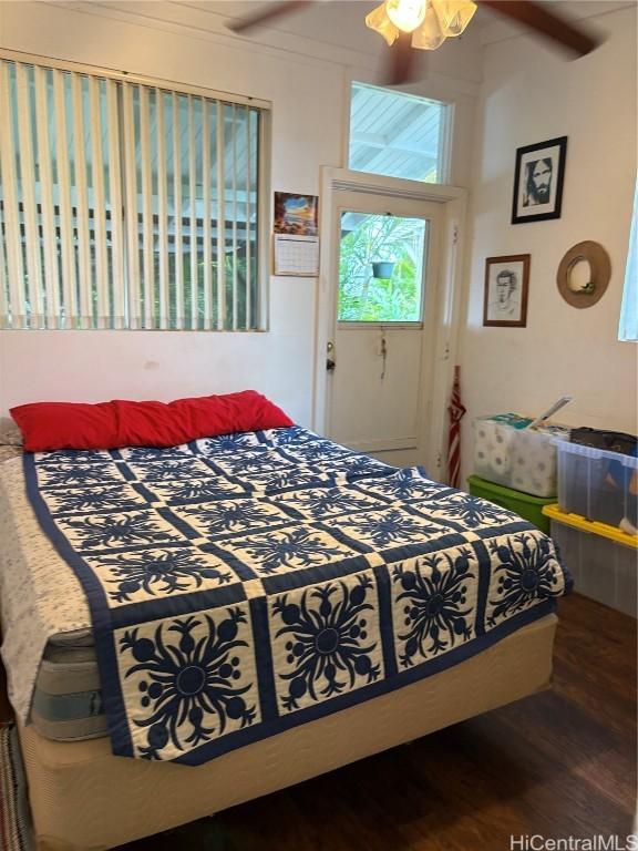 bedroom featuring dark wood-style flooring and ceiling fan