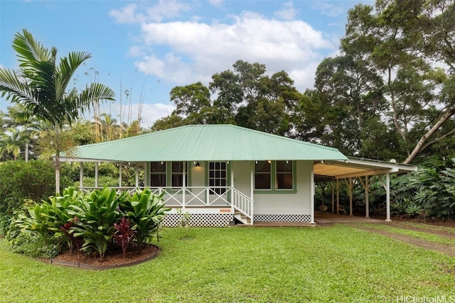 back of property featuring a carport and a yard