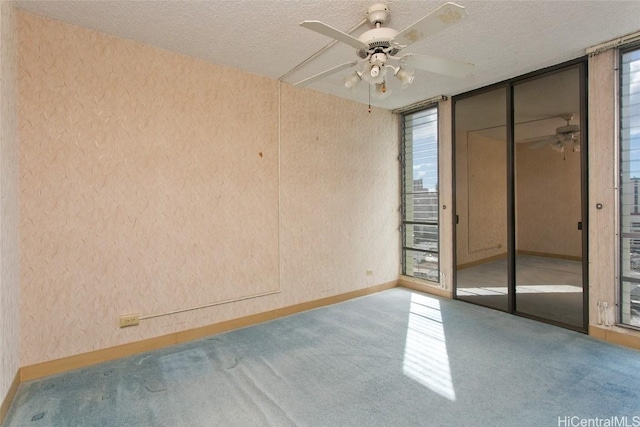 unfurnished bedroom with multiple windows, a textured ceiling, ceiling fan, and a closet