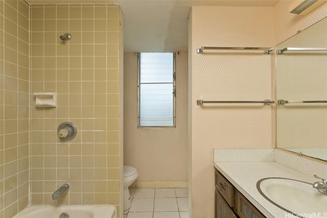 full bathroom featuring tiled shower / bath combo, vanity, tile patterned floors, and toilet