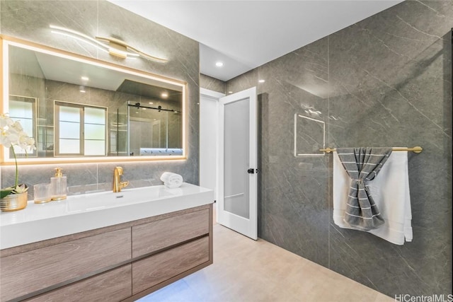 bathroom featuring tile walls, vanity, and an enclosed shower