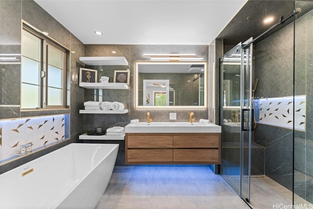 bathroom featuring vanity, separate shower and tub, and tile walls