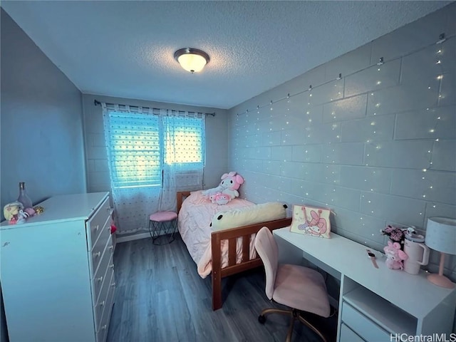 bedroom featuring dark hardwood / wood-style floors and a textured ceiling