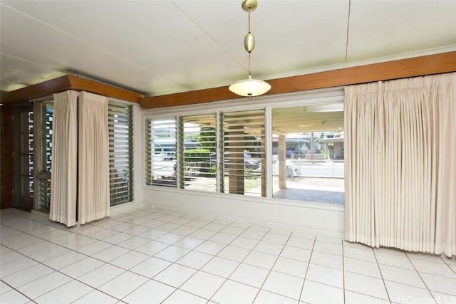 unfurnished room with light tile patterned flooring and plenty of natural light