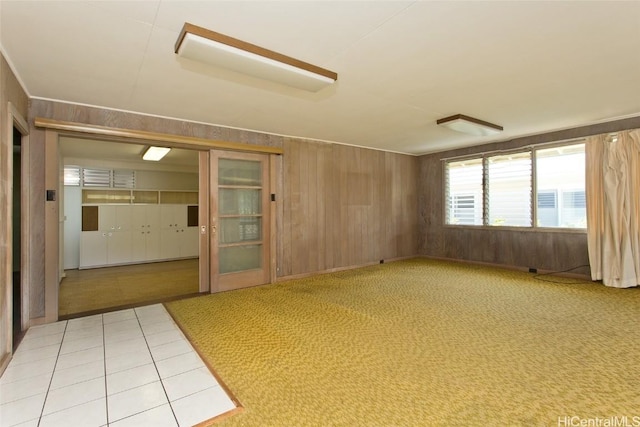 unfurnished room with wood walls