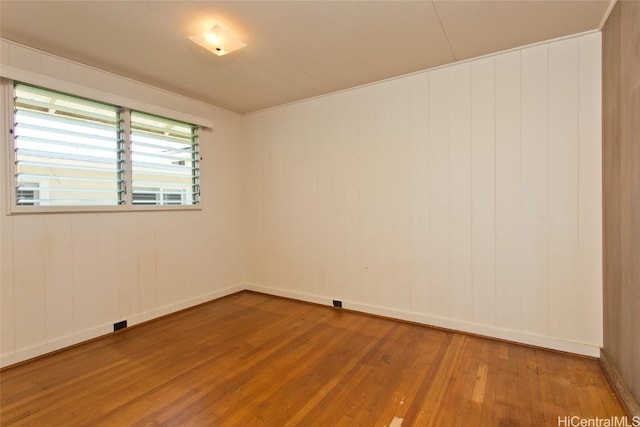 unfurnished room featuring hardwood / wood-style flooring