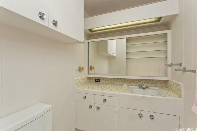 bathroom featuring decorative backsplash, toilet, and vanity