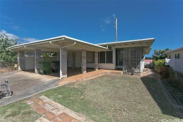 back of house featuring a patio area, a carport, driveway, and fence