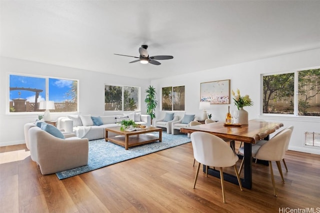 living room featuring ceiling fan, light hardwood / wood-style flooring, and a healthy amount of sunlight