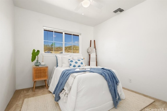 bedroom with light colored carpet and ceiling fan