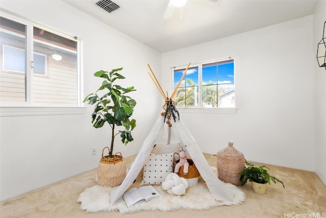 playroom with carpet and ceiling fan