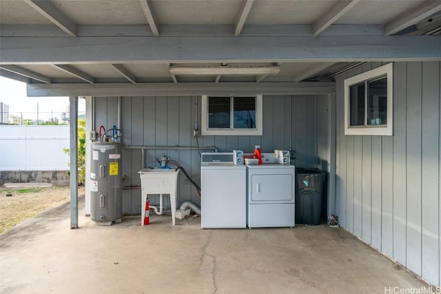 basement featuring independent washer and dryer, wooden walls, and electric water heater