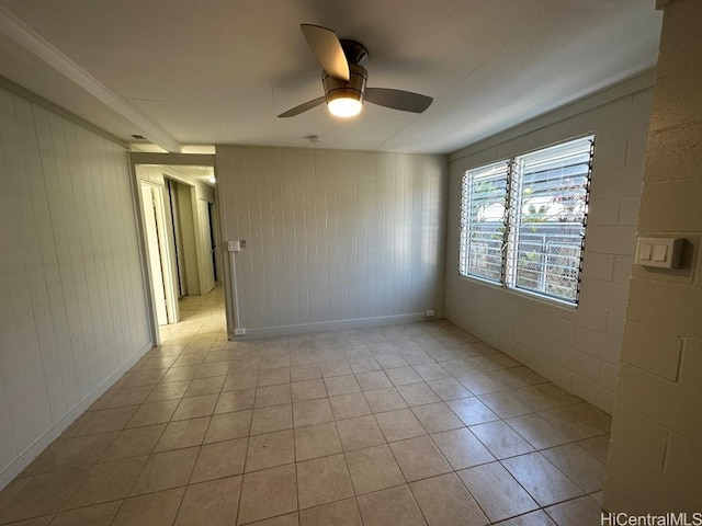 tiled empty room featuring ceiling fan