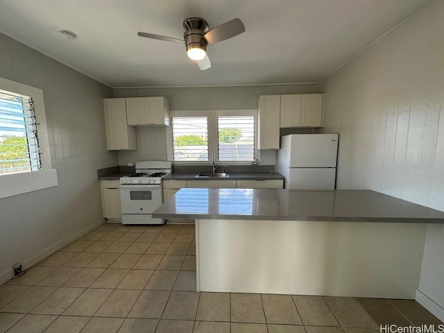 kitchen featuring light tile patterned flooring, sink, white cabinets, ceiling fan, and white appliances