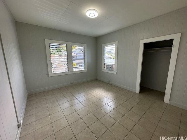 unfurnished bedroom with light tile patterned floors and a closet