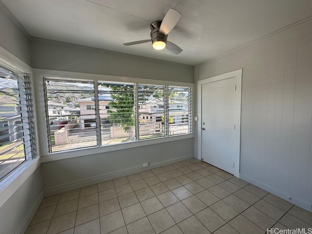 unfurnished room with ceiling fan and light tile patterned flooring