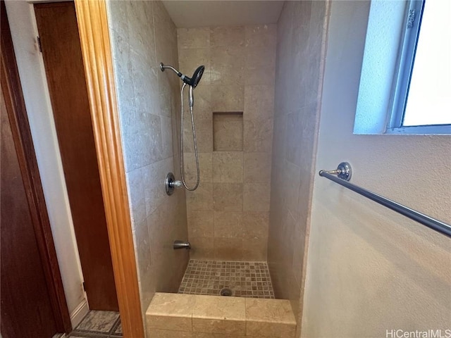 bathroom with tiled shower