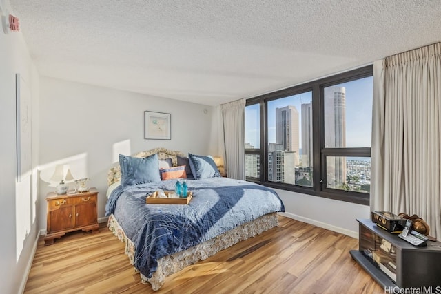 bedroom featuring a textured ceiling and light wood-type flooring