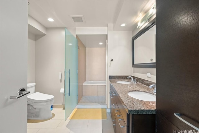 bathroom with tile patterned flooring, vanity, a shower with shower door, and toilet