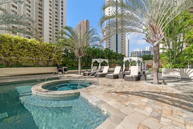 view of pool with a community hot tub and a patio area