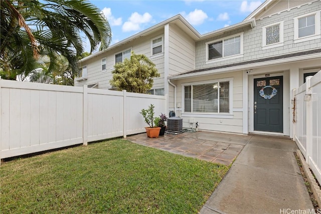 exterior space with a lawn, central air condition unit, and a patio area