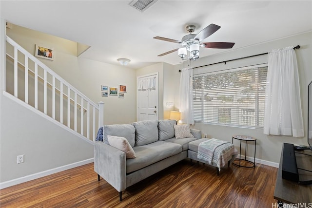 living room featuring ceiling fan and dark hardwood / wood-style flooring