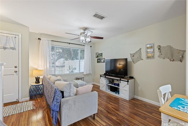 living room featuring ceiling fan and dark hardwood / wood-style flooring