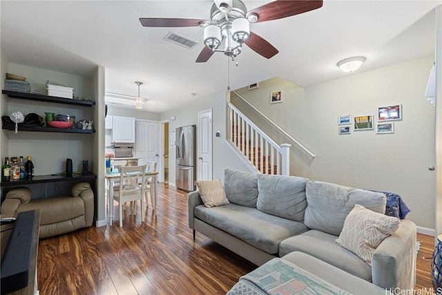 living room featuring dark hardwood / wood-style flooring and ceiling fan