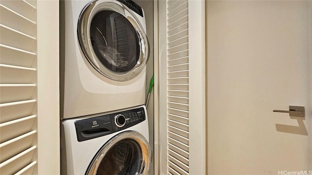 laundry area with stacked washer / drying machine