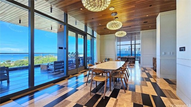 tiled dining space with an inviting chandelier, a water view, a wealth of natural light, and wooden ceiling