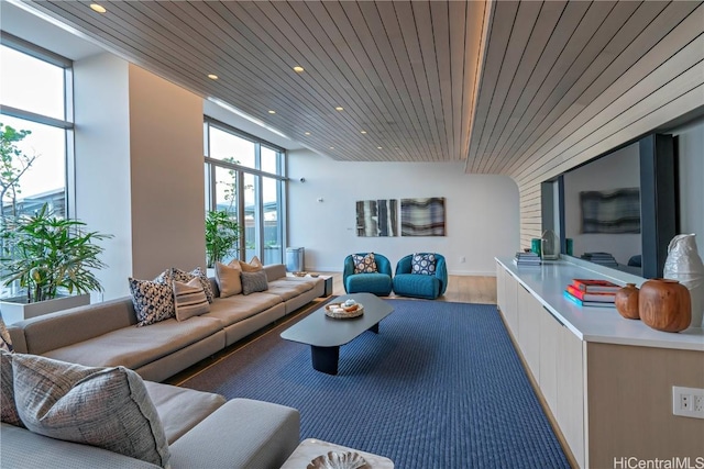 living room with wood ceiling, floor to ceiling windows, and hardwood / wood-style flooring