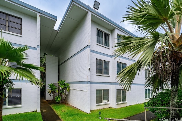 view of side of home featuring a lawn