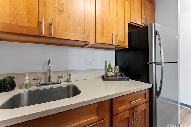 kitchen with sink and stainless steel fridge