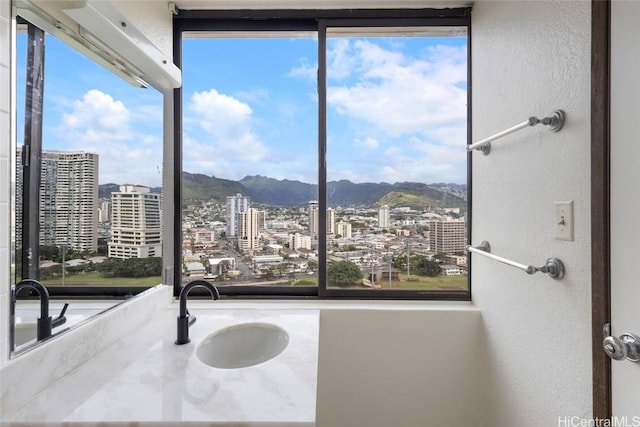 interior space featuring a healthy amount of sunlight, a mountain view, and sink