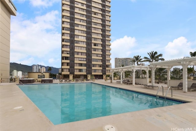 view of pool with a pergola and a patio