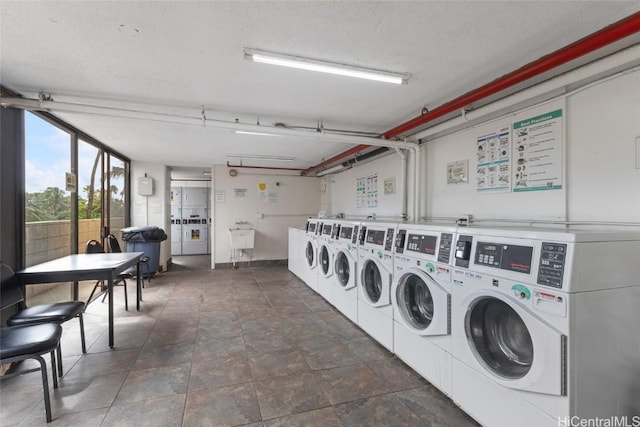 laundry room featuring washer and clothes dryer and a textured ceiling