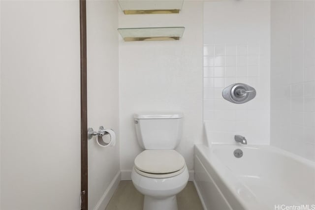 bathroom featuring tiled shower / bath and toilet