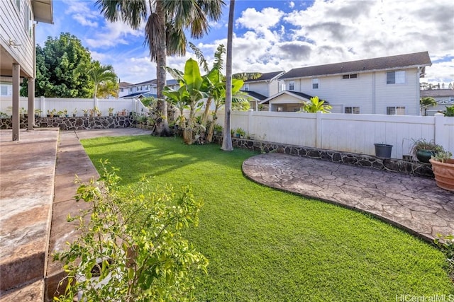 view of yard with a residential view, a patio area, and a fenced backyard