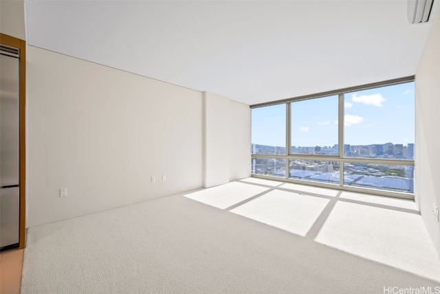 carpeted empty room featuring expansive windows, a wall mounted AC, and a city view