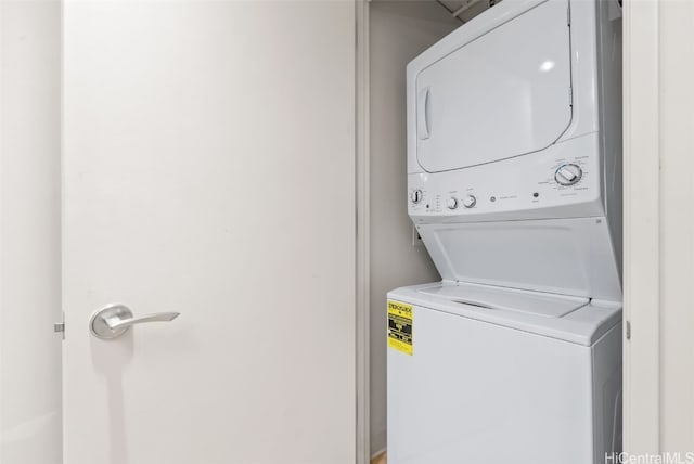 clothes washing area featuring laundry area and stacked washer and clothes dryer