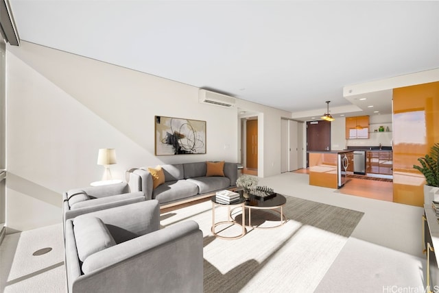 living room with an AC wall unit, sink, and light colored carpet