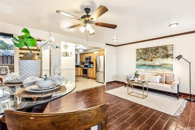 living room with ornamental molding and ceiling fan