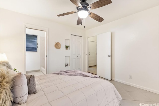 tiled bedroom with ceiling fan and a closet